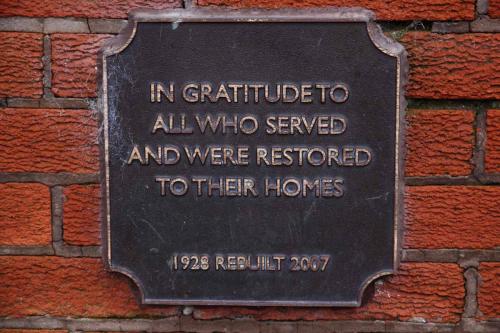  - Image of replica plaque.  The  original plaque was fixed to the centre wall of the shelter using wooded plugs and screws